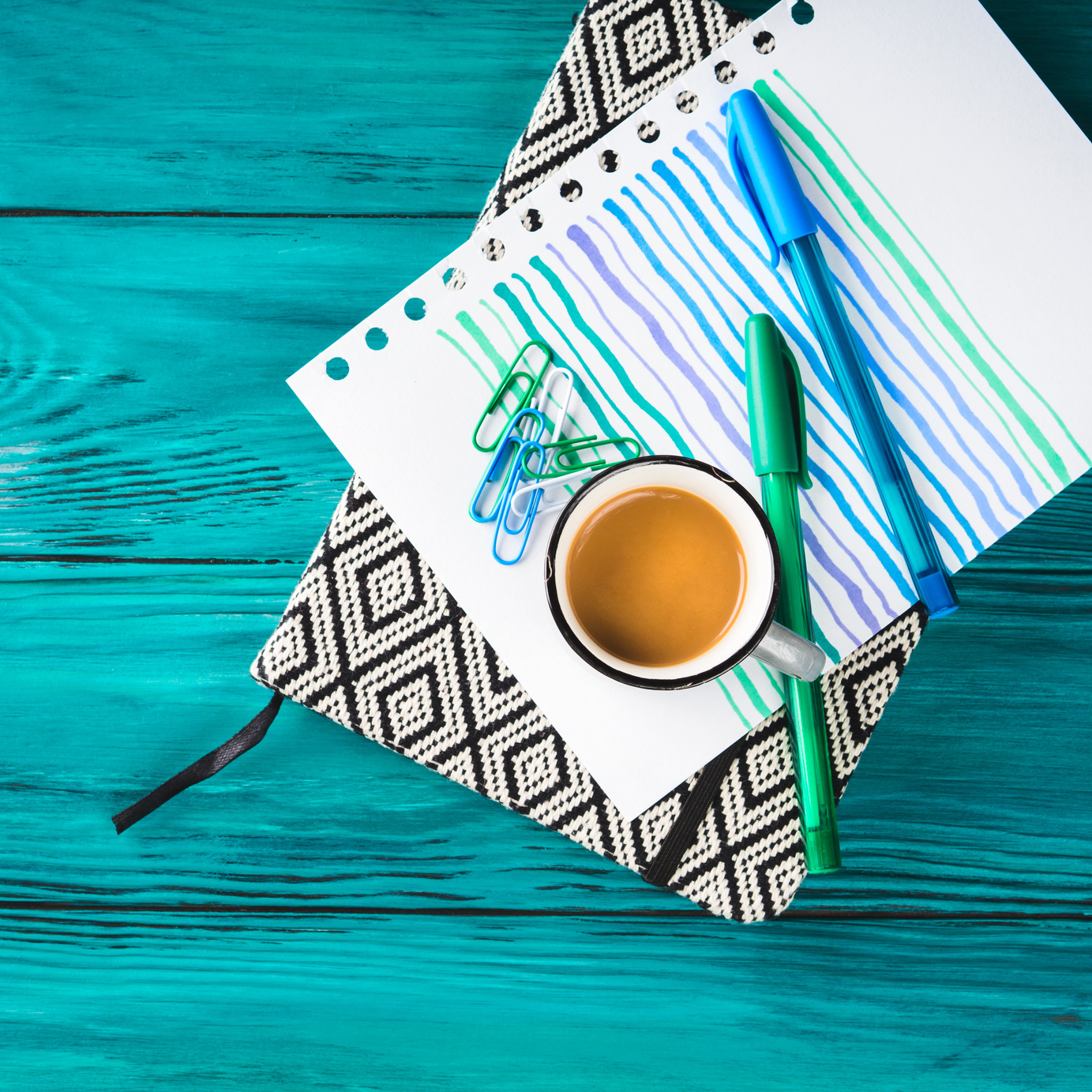 Cup of Coffee, Notebook and Pen on Dark